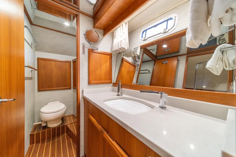 Slide: The Image of Luxurious 1995 Tollycraft 57 yacht bathroom with wood accents and modern fixtures. - 28