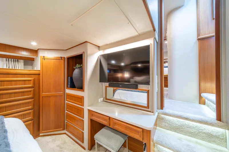 Slide: The Image of Luxurious interior of 1995 Tollycraft 57 Walk Around Pilothouse with wood cabinetry and modern TV. - 29