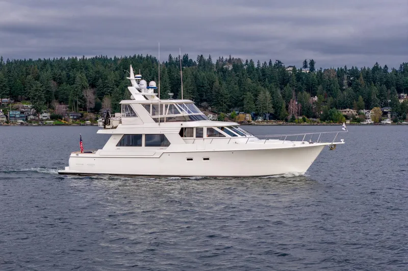 Slide: The Image of 1995 Tollycraft 57 Walk Around Pilothouse yacht cruising on a scenic lake. - 3
