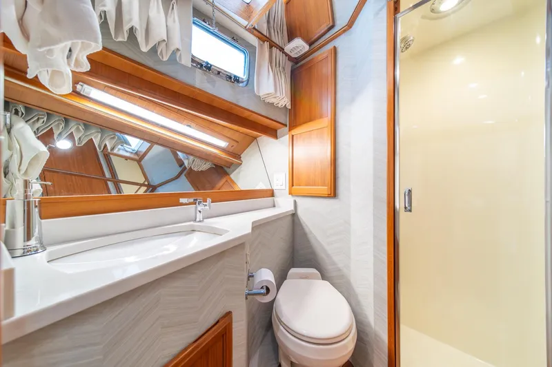 Slide: The Image of Luxurious bathroom in 1995 Tollycraft 57 Walk Around Pilothouse yacht, featuring modern fixtures. - 35