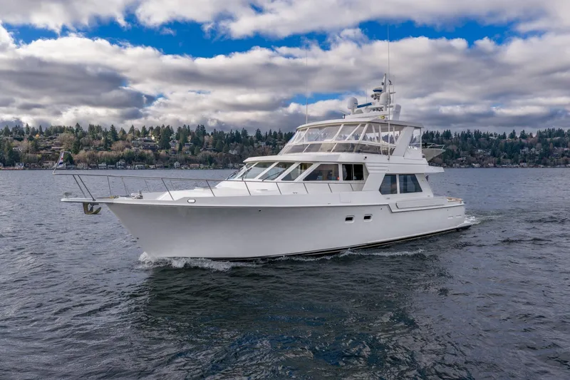 Slide: The Image of 1995 Tollycraft 57 Walk Around Pilothouse yacht cruising on a scenic lake. - 4