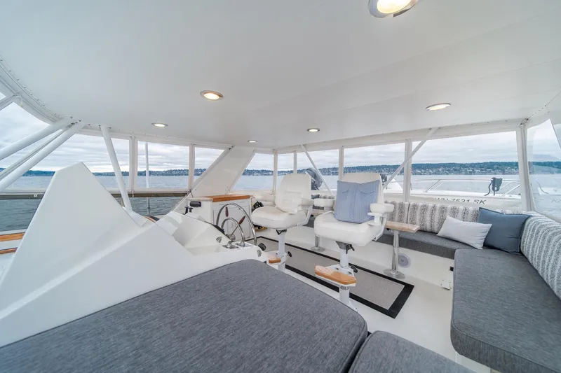 Slide: The Image of 1995 Tollycraft 57 Walk Around Pilothouse interior with seating and helm, overlooking water. - 41