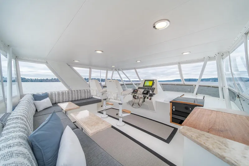 Slide: The Image of Luxurious 1995 Tollycraft 57 Walk Around Pilothouse interior with plush seating and modern helm. - 42