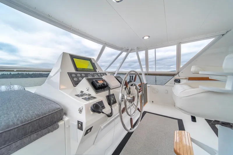 Slide: The Image of 1995 Tollycraft 57 Walk Around Pilothouse helm with modern navigation equipment and panoramic windows. - 43