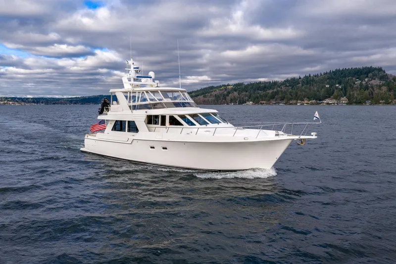 Slide: The Image of 1995 Tollycraft 57 Walk Around Pilothouse yacht cruising on a scenic lake. - 5