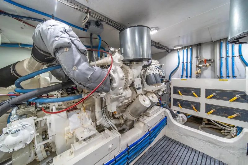 Slide: The Image of Engine room of 1995 Tollycraft 57 Walk Around Pilothouse with visible machinery and piping. - 60