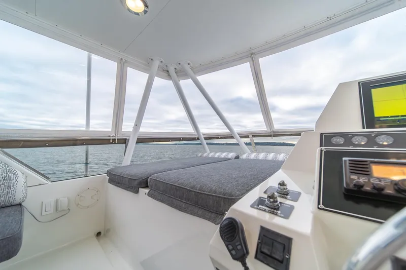 Slide: The Image of 1995 Tollycraft 57 Walk Around Pilothouse interior with navigation controls and cushioned seating. - 61
