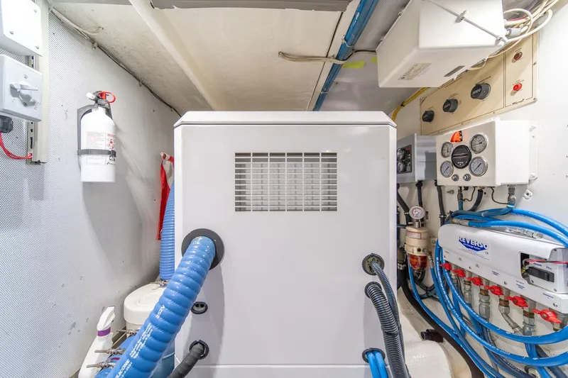 Slide: The Image of Engine room of 1995 Tollycraft 57 Walk Around Pilothouse with equipment and control panels. - 63