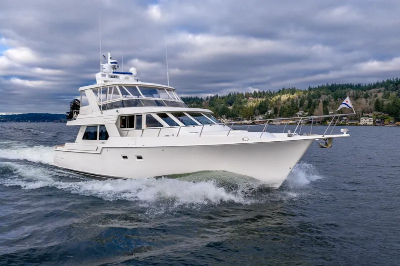 Slide: The Image of 1995 Tollycraft 57 Walk Around Pilothouse yacht cruising on a scenic lake. - 7