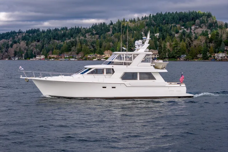 Slide: The Image of 1995 Tollycraft 57 Walk Around Pilothouse yacht cruising on a scenic lake. - 8