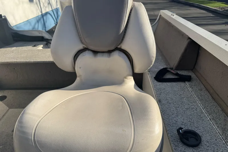 Slide: The Image of 2004 Crestliner 1650 Fish Hawk boat seat, showing wear and outdoor exposure. - 12