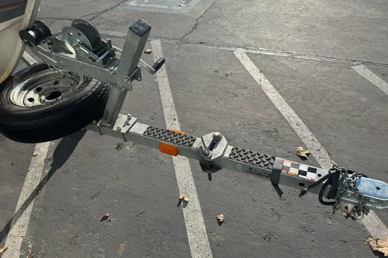 Slide: The Image of Trailer hitch of a 2004 Crestliner 1650 Fish Hawk boat in a parking lot. - 5