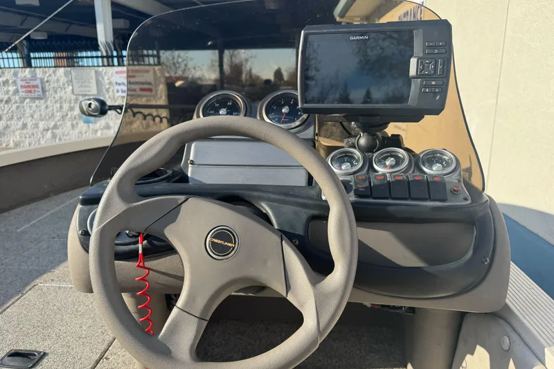 Slide: The Image of 2004 Crestliner 1650 Fish Hawk dashboard with steering wheel and Garmin GPS. - 7