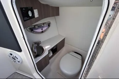 Slide: The Image of 2022 Regal LX6 boat interior bathroom with sink and toilet. - 10