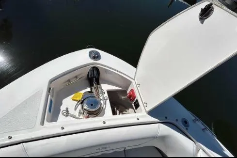 Slide: The Image of 2022 Regal LX6 boat anchor compartment with open hatch, showcasing storage and equipment. - 11