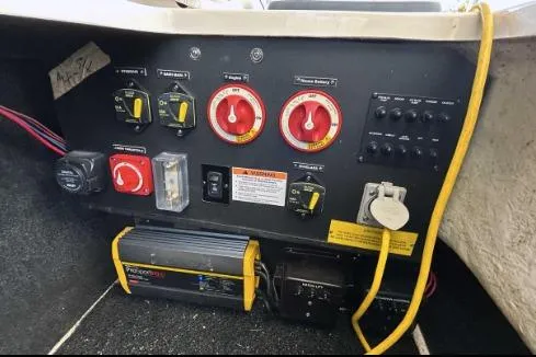 Slide: The Image of Control panel of a 2022 Regal LX6 boat with various switches and dials. - 12