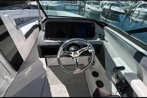 Slide: The Image of 2022 Regal LX6 boat cockpit with sleek steering wheel and modern dashboard controls. - 7