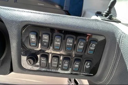 Slide: The Image of Control panel of 2022 Regal LX6 boat with various function buttons. - 8