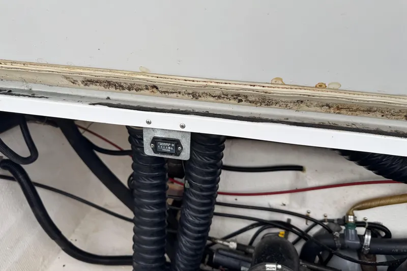 Slide: The Image of Engine compartment of a 1994 Cobalt 252 boat, showing hoses and wiring. - 13