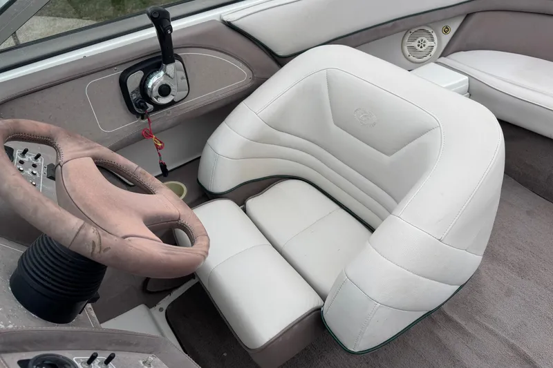 Slide: The Image of 1994 Cobalt 252 boat interior with white leather seat and steering wheel. - 14