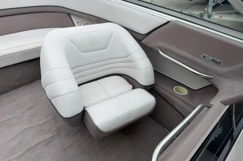 Slide: The Image of Interior of a 1994 Cobalt 252 boat featuring white and beige seating. - 15