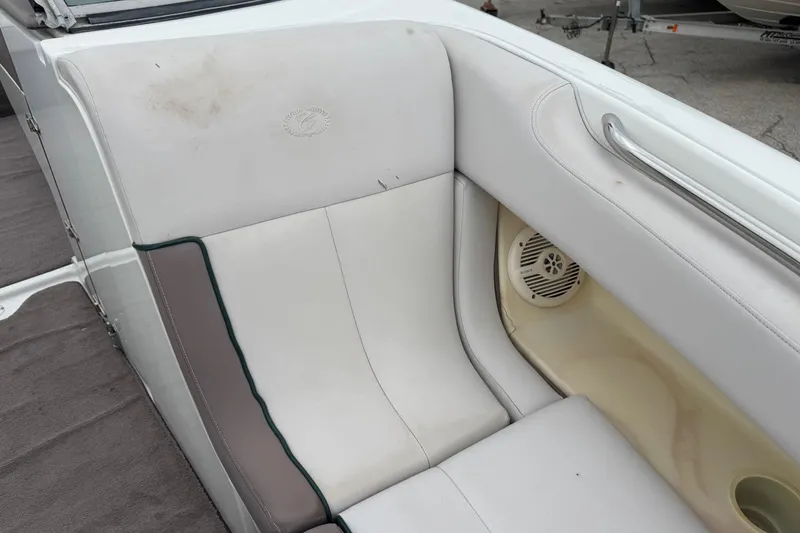 Slide: The Image of 1994 Cobalt 252 boat interior with white and gray seating, featuring a speaker. - 20
