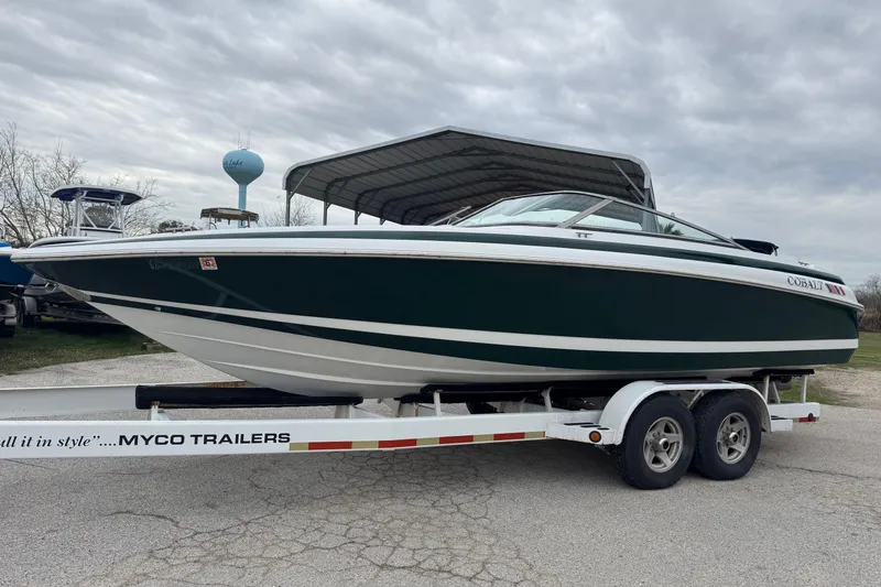 Slide: The Image of 1994 Cobalt 252 boat on trailer under cloudy sky. - 3