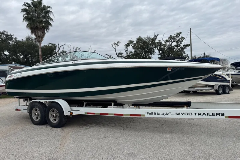 Slide: The Image of 1994 Cobalt 252 boat on Myco trailer, parked outdoors under cloudy sky. - 5
