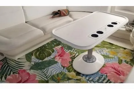 Slide: The Image of Interior of 2000 Sea Ray 460 Sundancer with floral rug and white seating. - 11