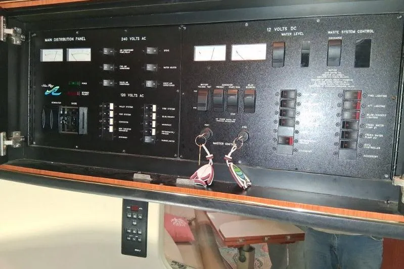 Slide: The Image of Control panel of a 2000 Sea Ray 460 Sundancer yacht, featuring various switches and gauges. - 12
