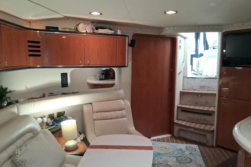 Slide: The Image of Interior of 2000 Sea Ray 460 Sundancer yacht with elegant wood cabinetry and cozy seating area. - 15