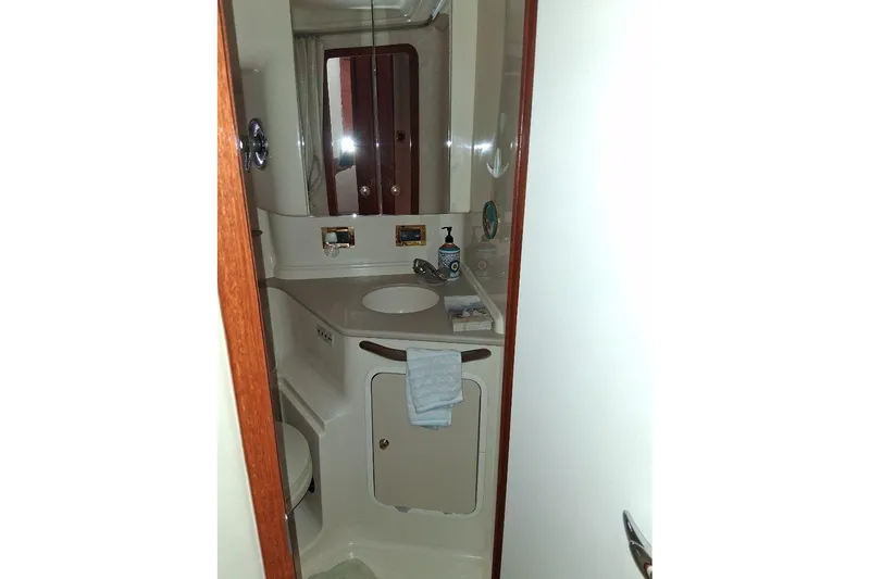 Slide: The Image of Bathroom interior of 2000 Sea Ray 460 Sundancer yacht, featuring sink and mirror. - 18