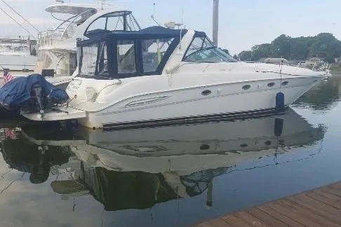 Slide: The Image of 2000 Sea Ray 460 Sundancer yacht docked in calm marina waters. - 5