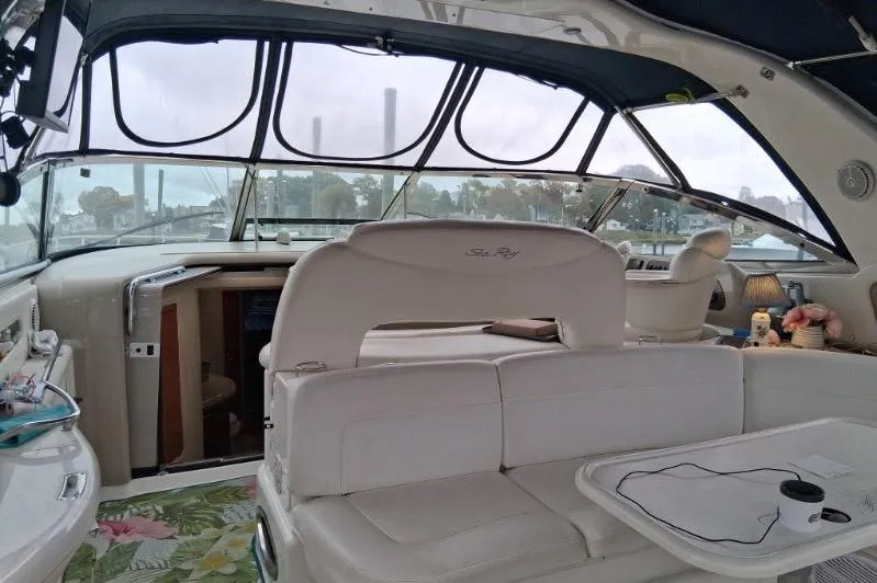 Slide: The Image of Interior of 2000 Sea Ray 460 Sundancer yacht with white seating and panoramic windows. - 8