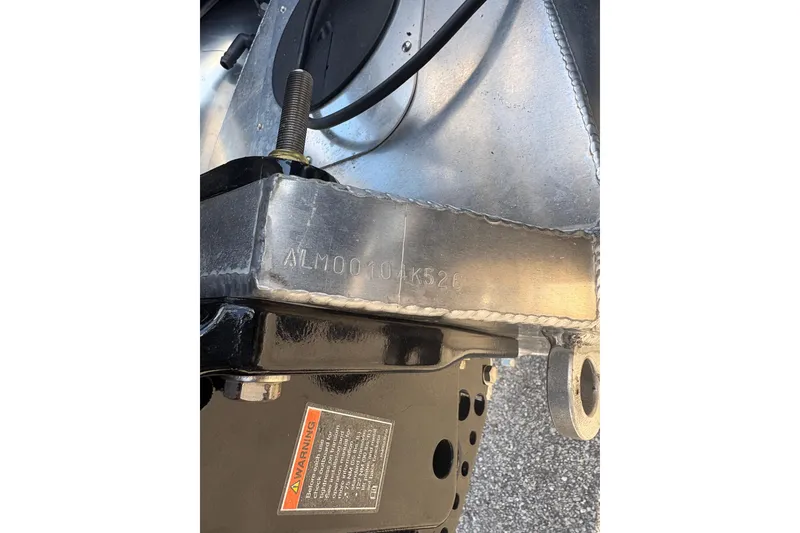 Slide: The Image of Close-up of Alera M 23Q 2026 vehicle part with serial number and warning label. - 11