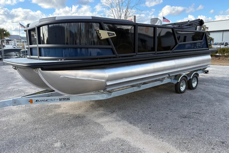 Slide: The Image of 2026 Alera M 23Q pontoon boat on trailer under a cloudy sky. - 14