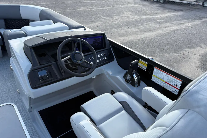 Slide: The Image of Interior of 2026 Alera M 23Q boat, featuring modern steering and control panel. - 8