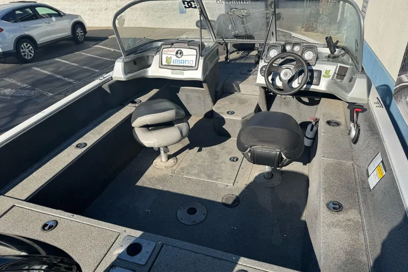Slide: The Image of 2018 Tracker Pro Guide V-165 WT boat interior with seating and steering console. - 10