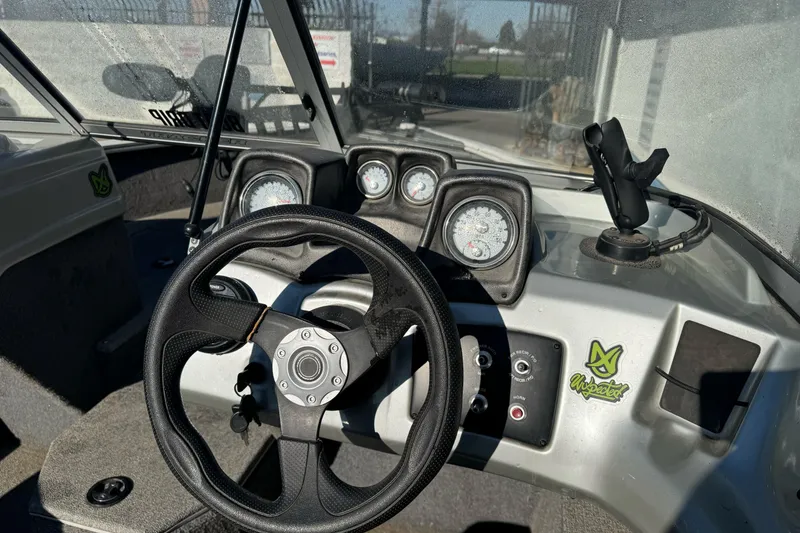 Slide: The Image of 2018 Tracker Pro Guide V-165 WT boat dashboard with steering wheel and gauges. - 12