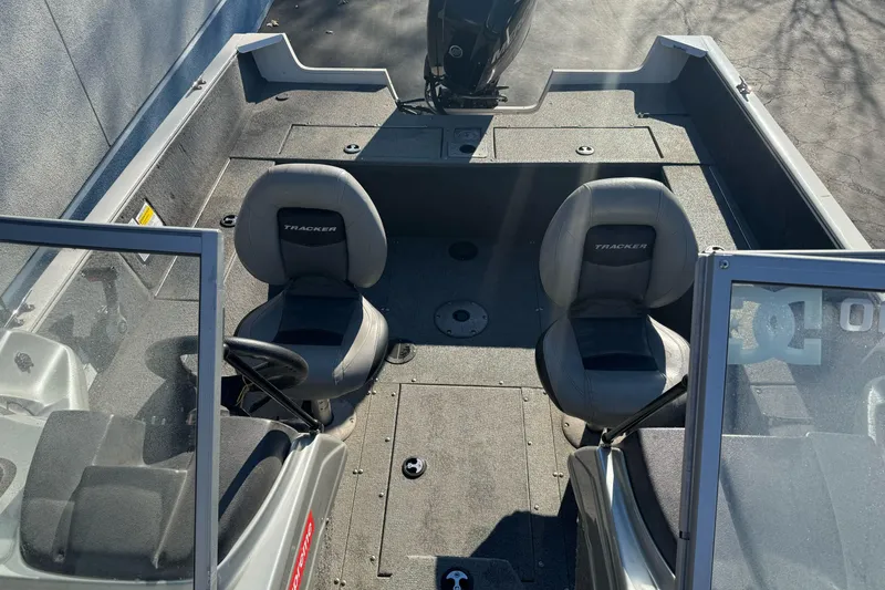 Slide: The Image of 2018 Tracker Pro Guide V-165 WT boat interior with two seats and steering console. - 14