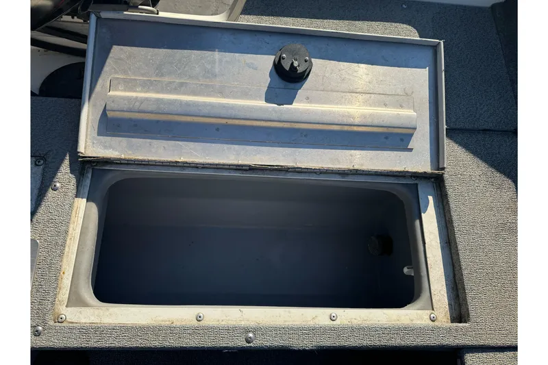 Slide: The Image of Open storage compartment on 2018 Tracker Pro Guide V-165 WT boat. - 18