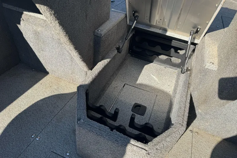 Slide: The Image of 2018 Tracker Pro Guide V-165 WT boat storage compartment with open lid and carpeted interior. - 20