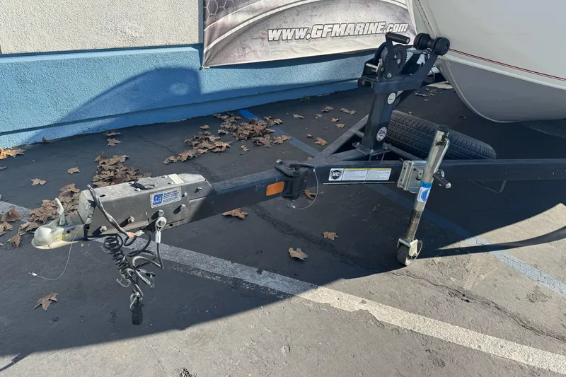 Slide: The Image of Trailer hitch of 2018 Tracker Pro Guide V-165 WT boat in parking lot. - 4