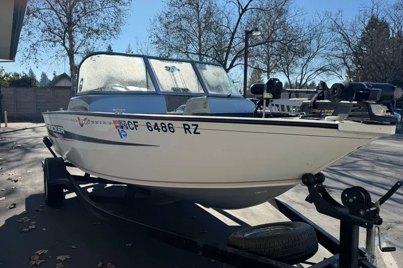 Slide: The Image of 2018 Tracker Pro Guide V-165 WT boat on trailer, parked outdoors. - 5