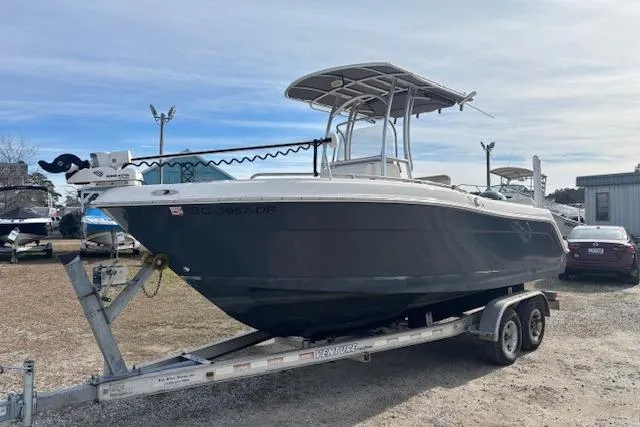 The Image of 2014 Robalo R222 Center Console boat on trailer, parked outdoors. - 0