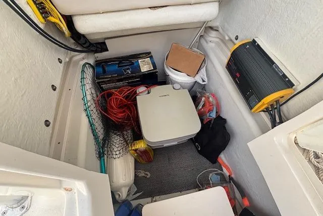 Slide: The Image of Storage compartment of 2014 Robalo R222 Center Console with fishing gear and equipment. - 21