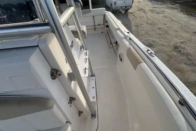 Slide: The Image of 2014 Robalo R222 Center Console boat interior with seating and storage compartments. - 23