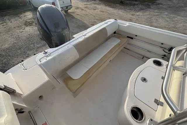 Slide: The Image of 2014 Robalo R222 Center Console boat interior with seating and engine view. - 27