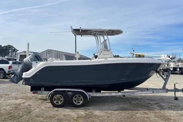 Slide: The Image of 2014 Robalo R222 Center Console boat on trailer, parked outdoors. - 5