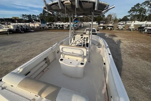 Slide: The Image of 2014 Robalo R222 Center Console boat in a marina, showcasing spacious deck and console. - 8